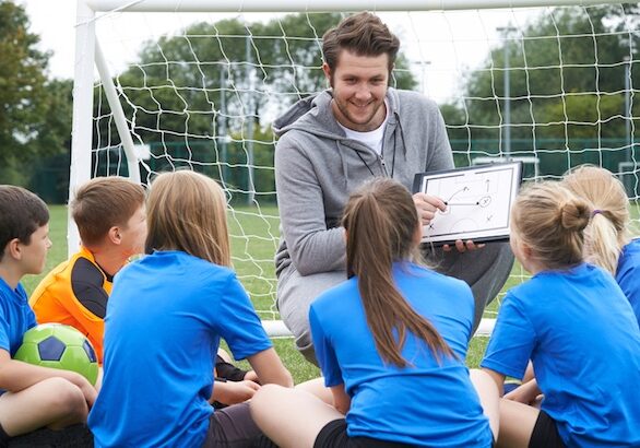 Soccer-coach-talking-to-young-players-